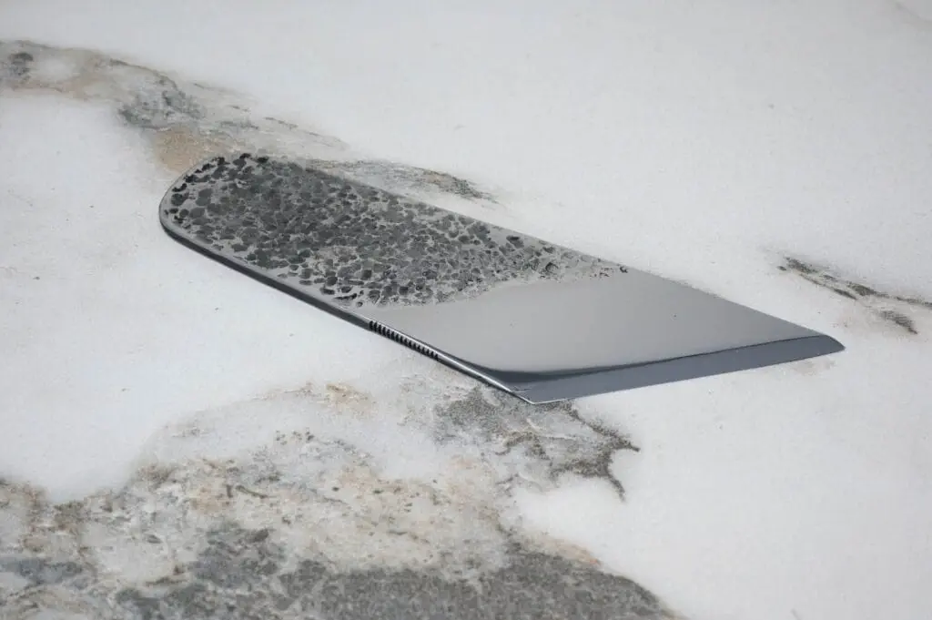 The Limited Edition Monster Clicker rests elegantly on a textured marble surface.
